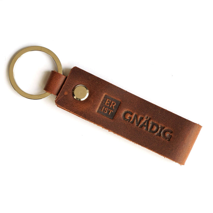 Schlüsselanhänger "ER IST GNÄDIG" · Echtes Leder · Prägung – Aus Gnade